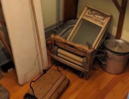 Washboards, a laundry wringer, an ironing board, and a carpet sweeper in a Rutherford House closet